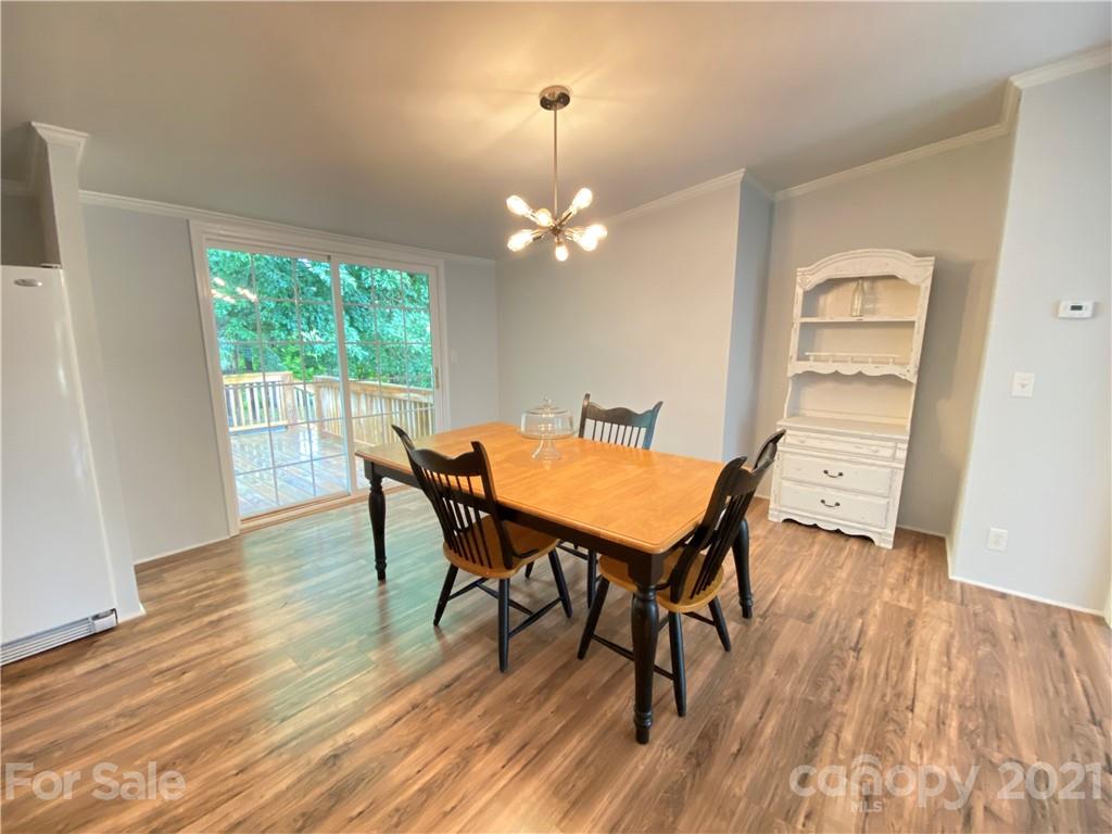 7210 Medlin Road Monroe, NC 28112 - Photo 13 of 30 a view of a dining room with furniture window and wooden floor