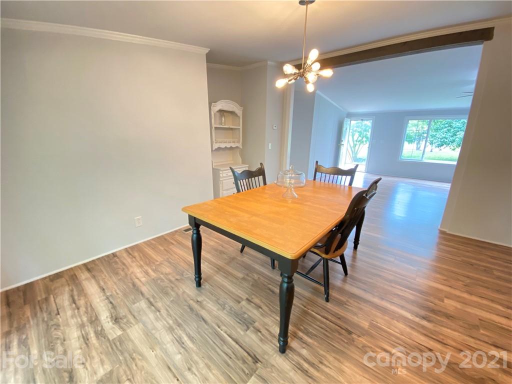 7210 Medlin Road Monroe, NC 28112 - Photo 14 of 30 a view of a dining room with furniture and wooden floor