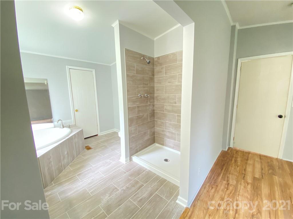 7210 Medlin Road Monroe, NC 28112 - Photo 16 of 30 a bathroom with a tub shower and sink