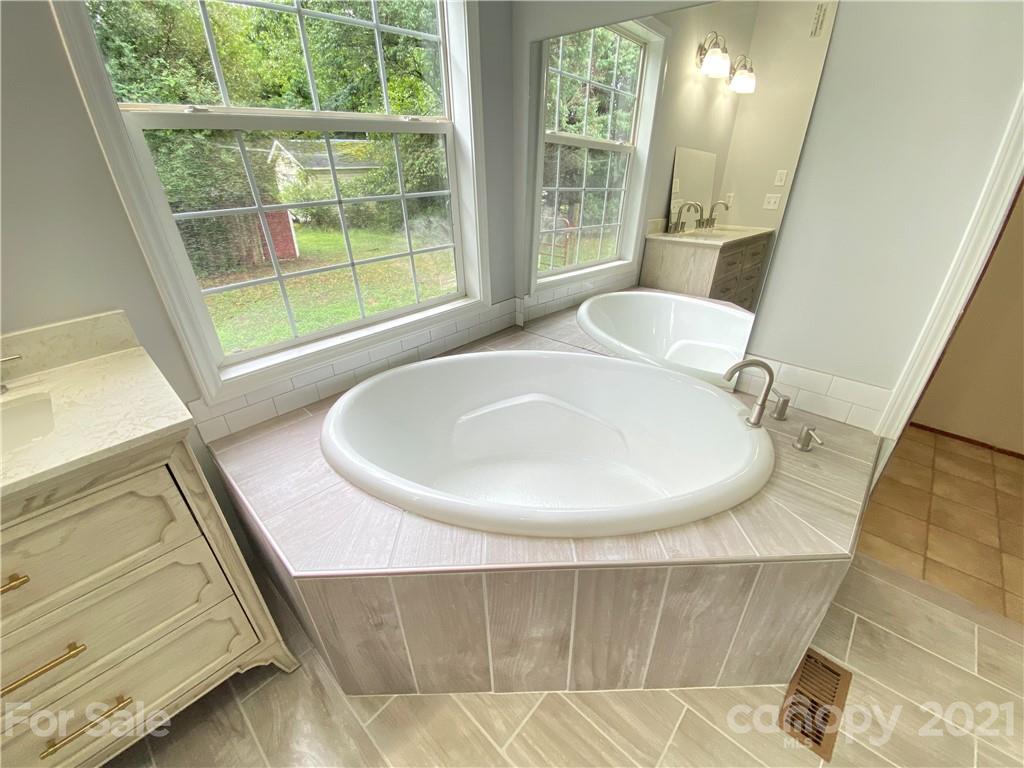 7210 Medlin Road Monroe, NC 28112 - Photo 17 of 30 a bathroom with a sink and a bathtub