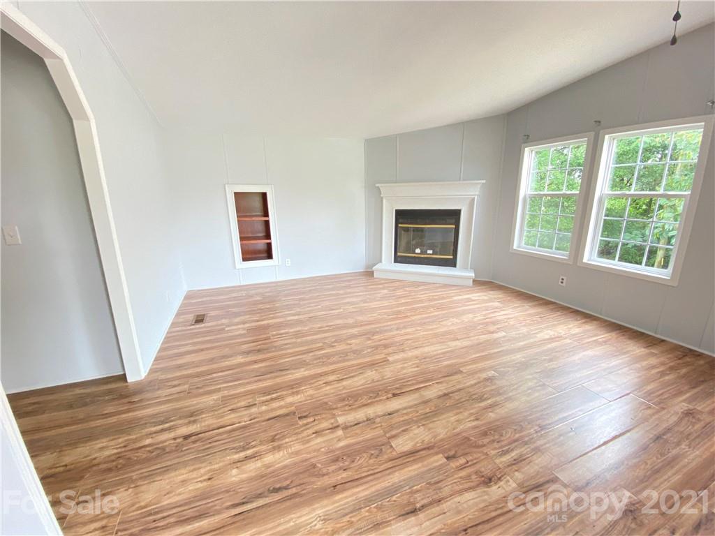 7210 Medlin Road Monroe, NC 28112 - Photo 27 of 30 a view of an empty room with wooden floor and a window