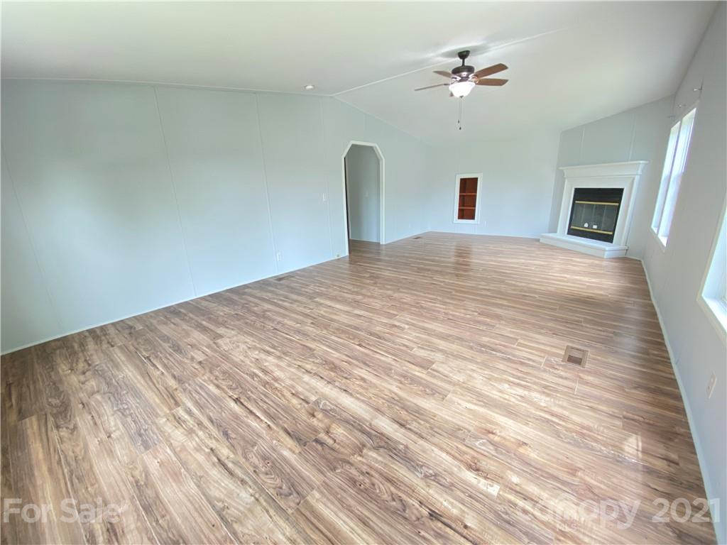 7210 Medlin Road Monroe, NC 28112 - Photo 28 of 30 a bedroom with a bed and a chandelier