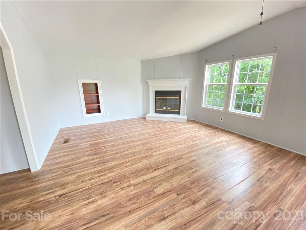 7210 Medlin Road Monroe, NC 28112 - Photo 30 of 30 a view of an empty room with wooden floor and a window