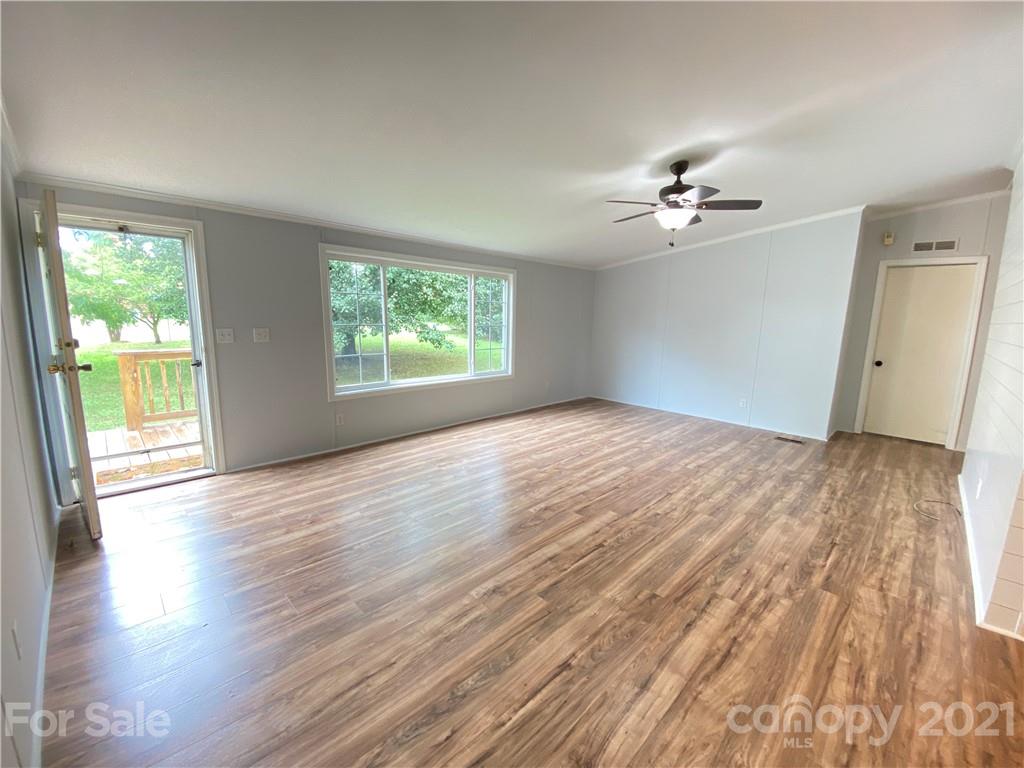7210 Medlin Road Monroe, NC 28112 - Photo 6 of 30 a view of empty room with wooden floor and fan