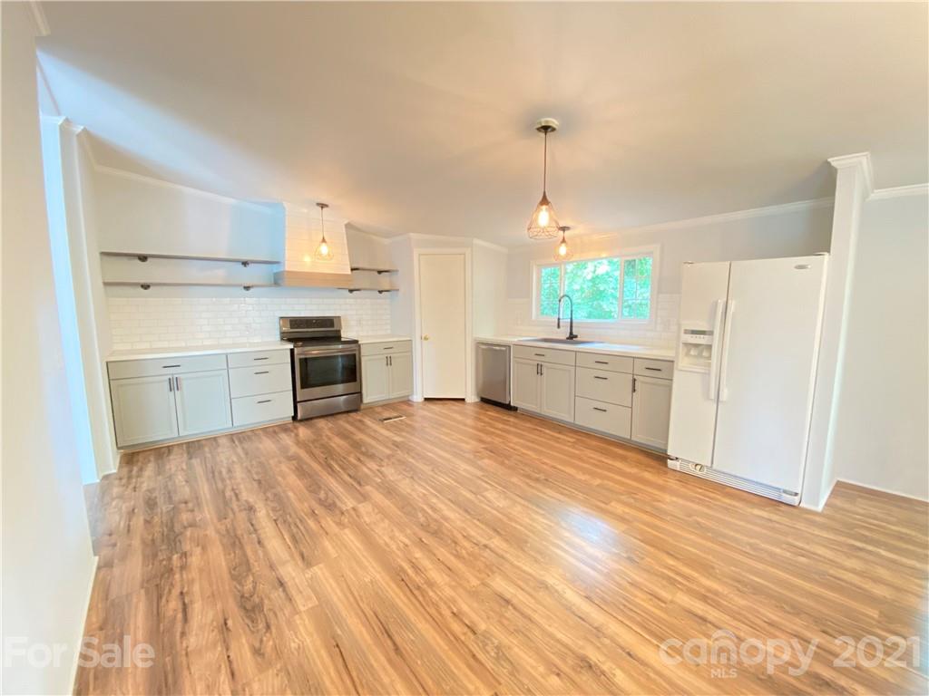 7210 Medlin Road Monroe, NC 28112 - Photo 8 of 30 a room with a bed and a view of kitchen