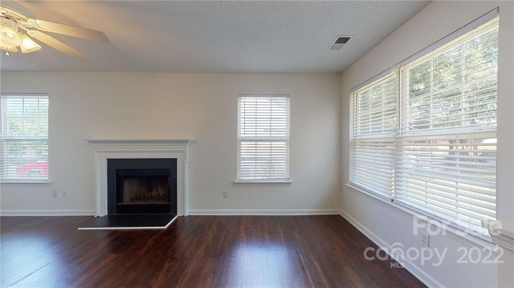 8821 Cameron Spring Road Charlotte, NC 28214 - Photo 11 of 40 a view of an empty room with wooden floor and a window