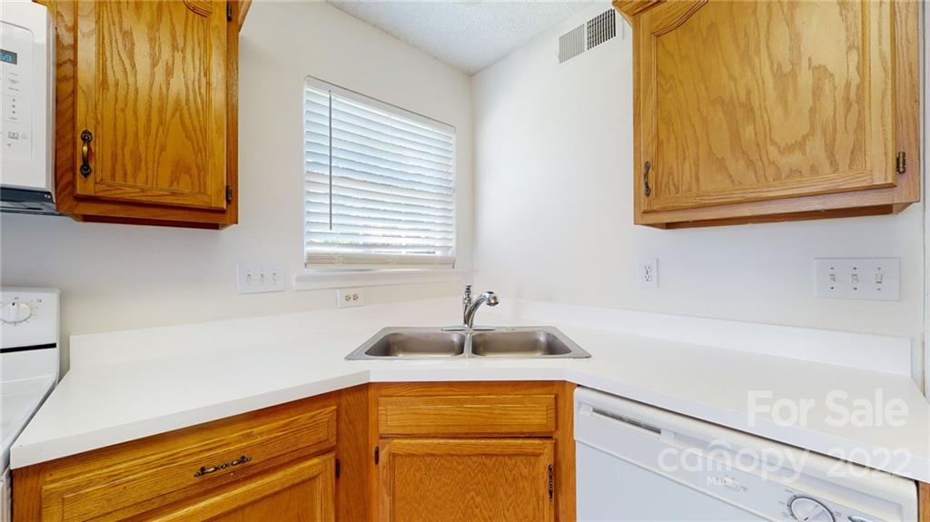 8821 Cameron Spring Road Charlotte, NC 28214 - Photo 16 of 40 a kitchen with a sink and cabinets