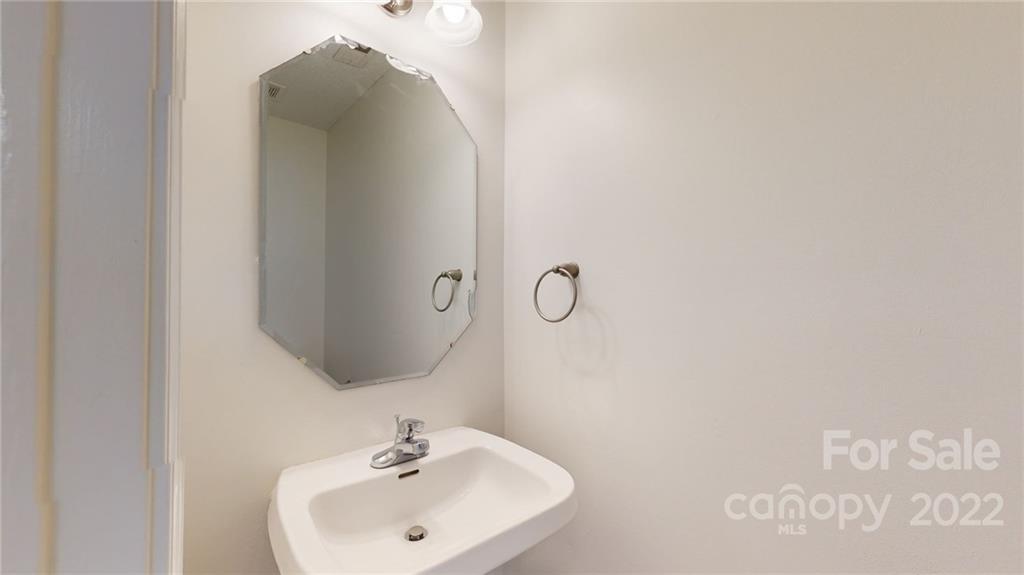 8821 Cameron Spring Road Charlotte, NC 28214 - Photo 21 of 40 a bathroom with a sink and mirror