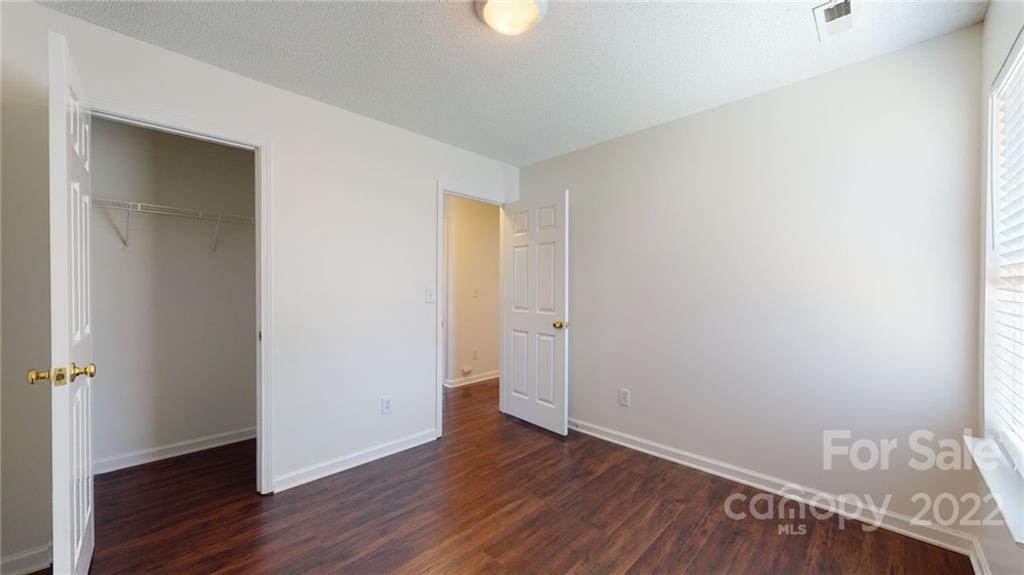 8821 Cameron Spring Road Charlotte, NC 28214 - Photo 25 of 40 a view of an empty room with wooden floor
