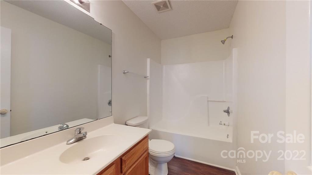 8821 Cameron Spring Road Charlotte, NC 28214 - Photo 26 of 40 a bathroom with a sink a toilet and shower