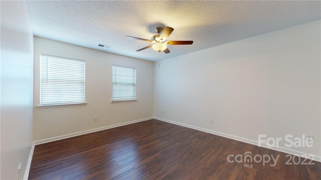 8821 Cameron Spring Road Charlotte, NC 28214 - Photo 28 of 40 wooden floor in an empty room with a window