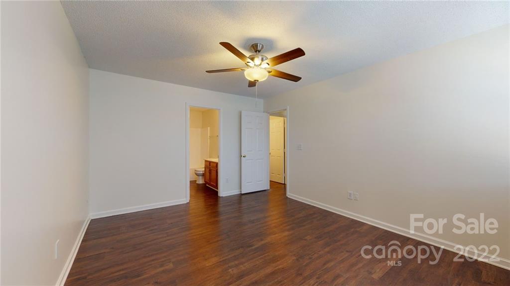 8821 Cameron Spring Road Charlotte, NC 28214 - Photo 29 of 40 a view of an empty room with window and wooden floor