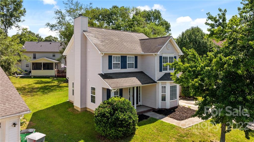 8821 Cameron Spring Road Charlotte, NC 28214 - Photo 5 of 40 a aerial view of a house with a yard table and chairs