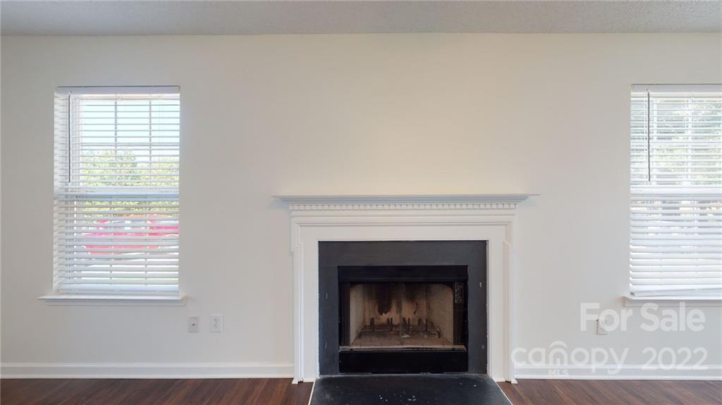 8821 Cameron Spring Road Charlotte, NC 28214 - Photo 9 of 40 a living room with a fireplace and a window