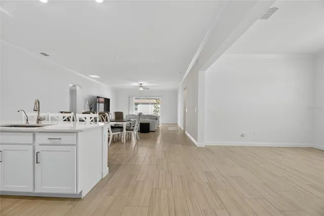 a kitchen with stainless steel appliances kitchen island granite countertop a refrigerator and a stove top oven