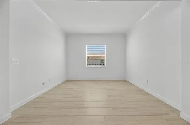 a kitchen with stainless steel appliances a dining table chairs and granite counter tops