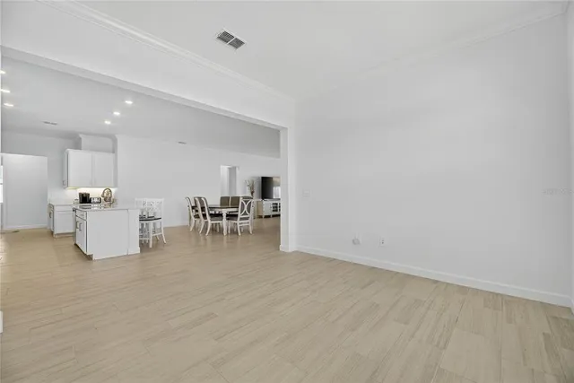 a kitchen with white cabinets and appliances