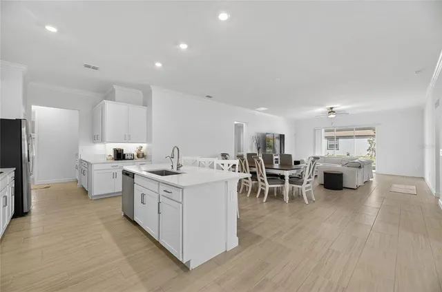a kitchen with stainless steel appliances granite countertop white cabinets and sink