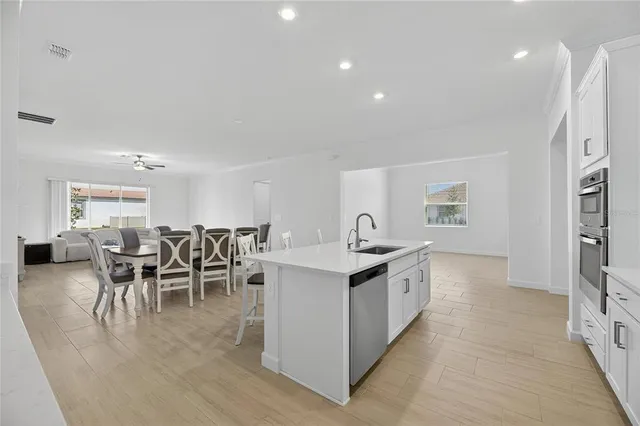 a view of a dining room with furniture and a chandelier