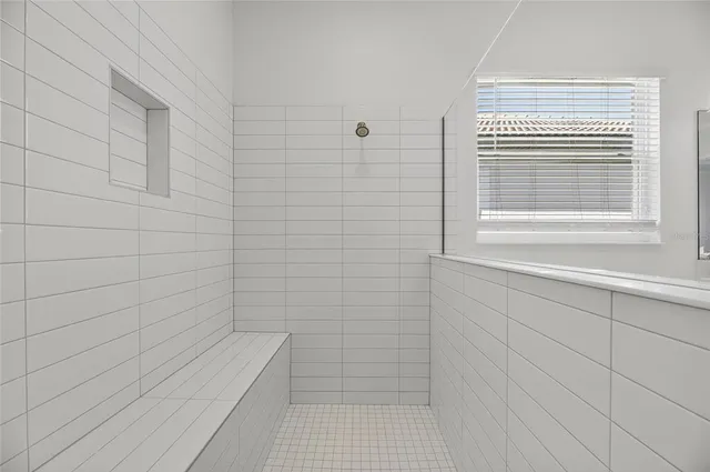 a white house with a yard and a large tree