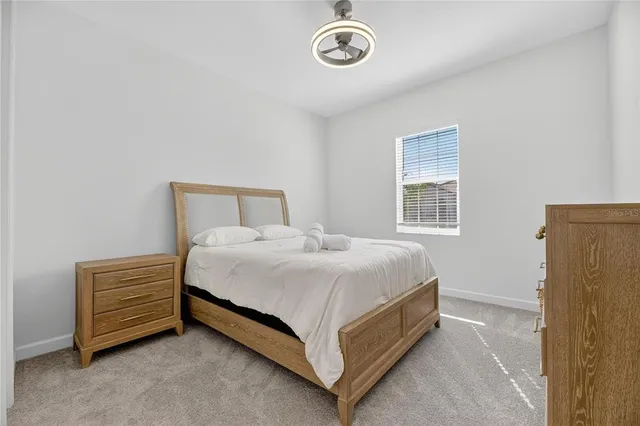 a bathroom with a sink a toilet and a large mirror
