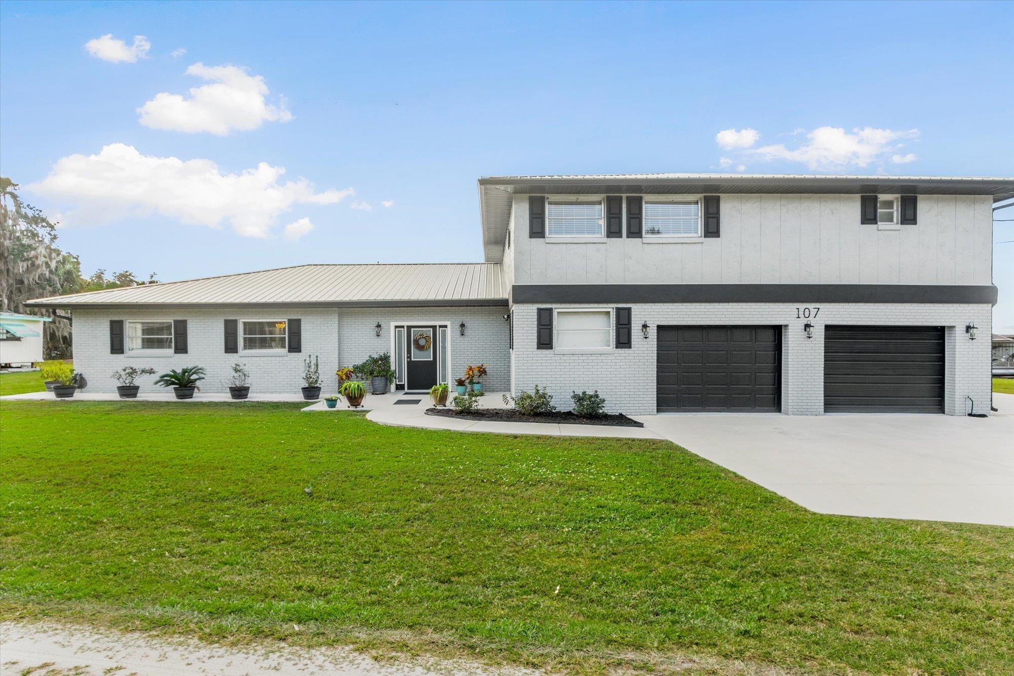 107 Betty Road Crescent City, FL 32112 - Photo 1 of 65 a front view of house with yard and outdoor seating