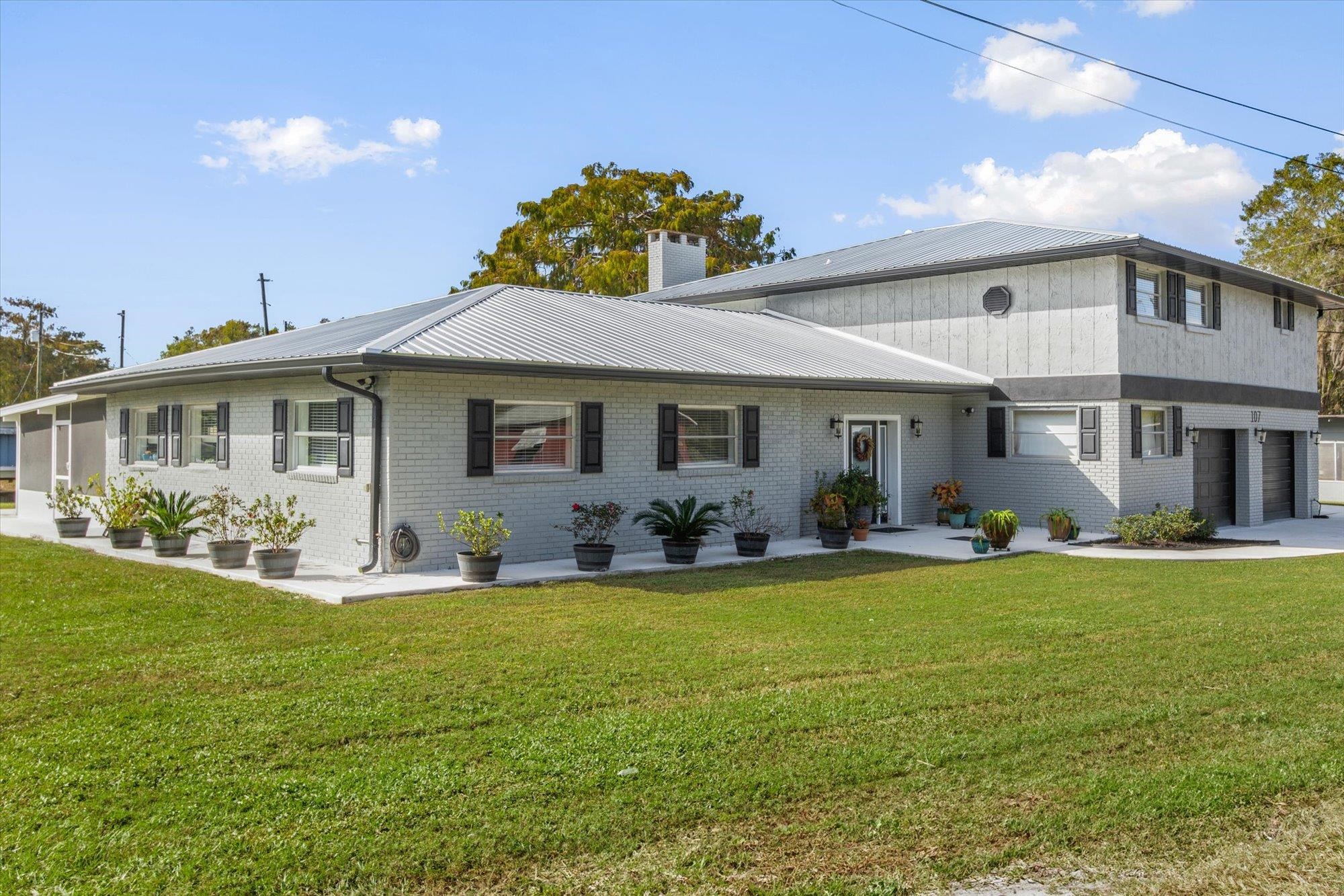 107 Betty Road Crescent City, FL 32112 - Photo 39 of 65 a front view of a house with swimming pool having outdoor seating