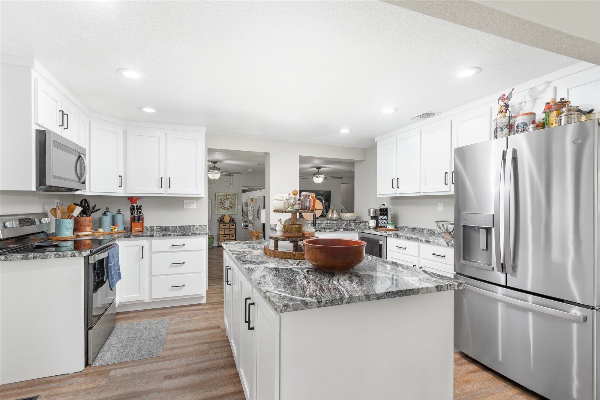 107 Betty Road Crescent City, FL 32112 - Photo 10 of 65 a kitchen with stainless steel appliances granite countertop a refrigerator stove microwave and sink