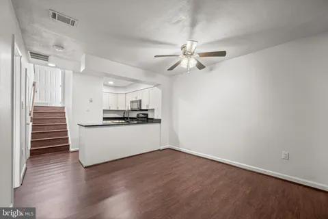 a view of kitchen with wooden floor and electronic appliances