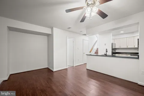 a view of kitchen with stainless steel appliances wooden floor