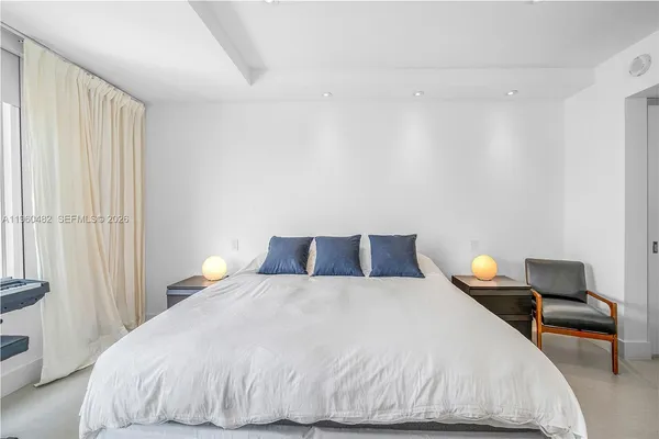 a bedroom with a bed and chair