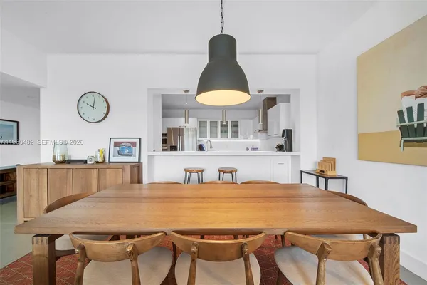a kitchen with a table chairs a stove and a dining table