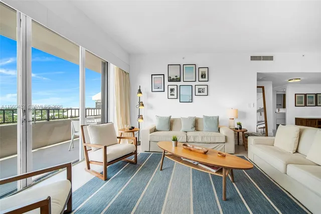 a living room with furniture and a floor to ceiling window