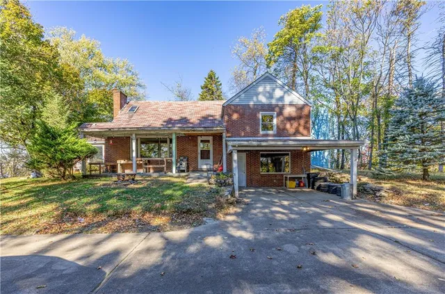 a view of a house with a yard porch and sitting area