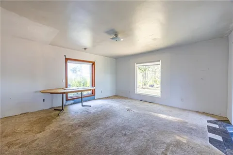 a view of a room with windows a ceiling fan and a window