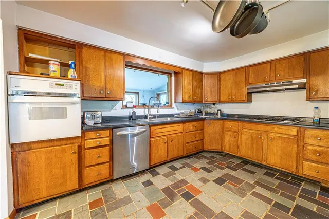 a kitchen with stainless steel appliances granite countertop a sink and cabinets
