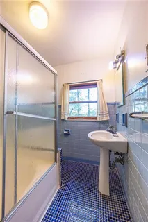 a bathroom with a sink a toilet and bathtub