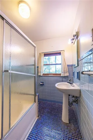 a bathroom with a sink a toilet and bathtub