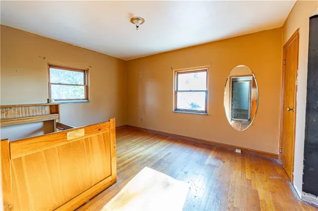 a view of a room with wooden floor and cabinet
