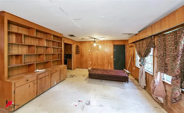 a kitchen with granite countertop cabinets and wooden floor