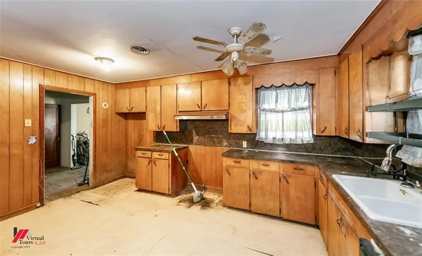 a kitchen with stainless steel appliances granite countertop a sink and cabinets