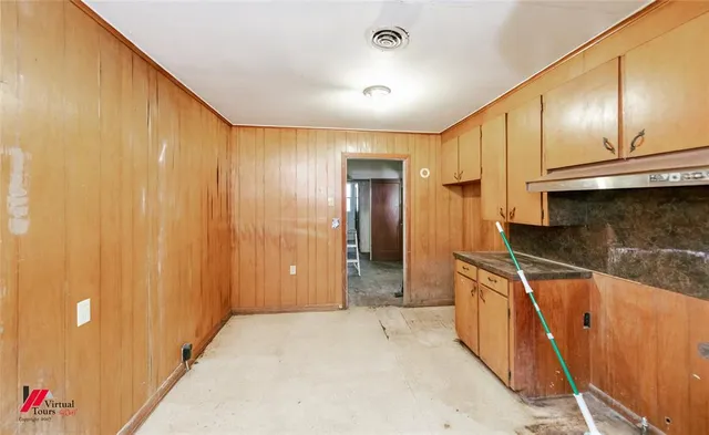 a kitchen with stainless steel appliances granite countertop a sink and a refrigerator