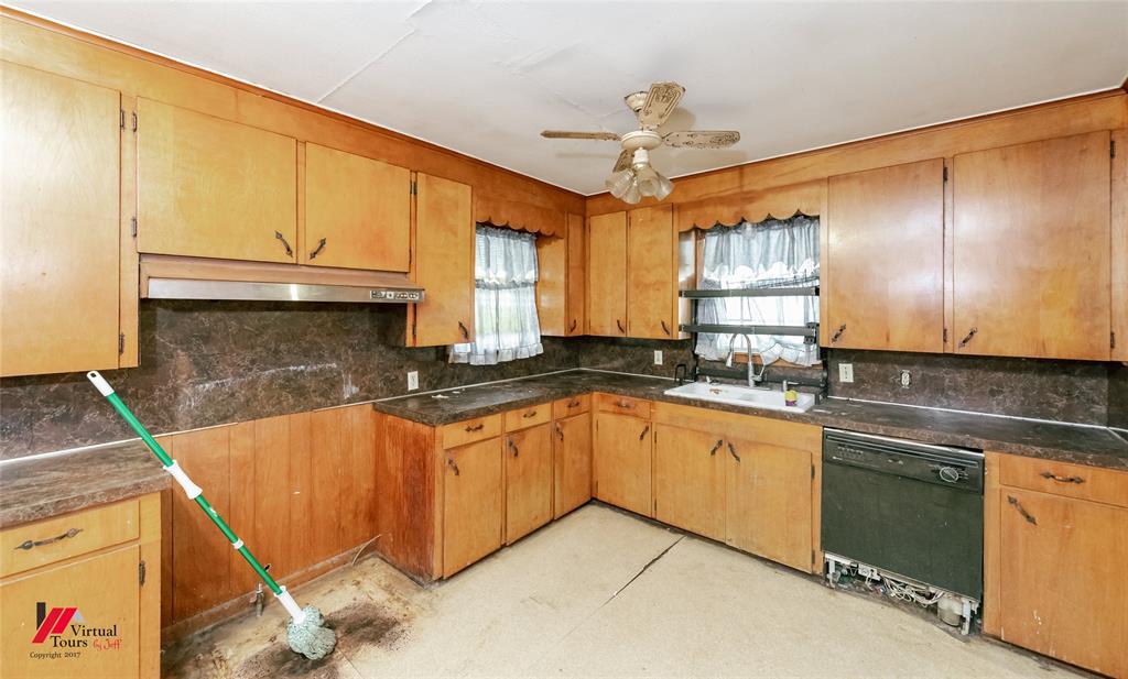 206 North Street Springhill, LA 71075 - Photo 22 of 28 a kitchen with stainless steel appliances granite countertop a sink and cabinets