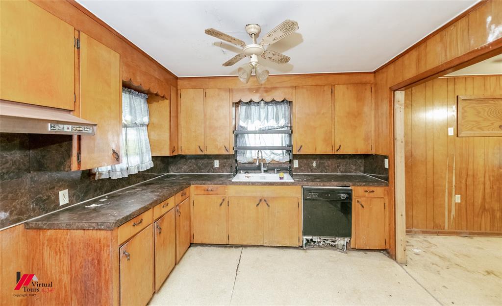206 North Street Springhill, LA 71075 - Photo 23 of 28 a kitchen with stainless steel appliances granite countertop a sink and a refrigerator