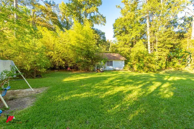 a view of house with a backyard
