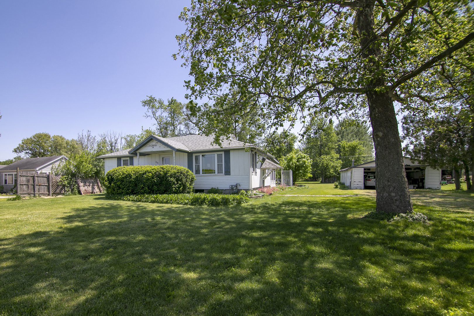 2244 West 2000S Road Kankakee, IL 60901 - Photo 3 of 29 a view of a house with a big yard and large trees
