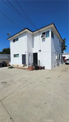 a view of a patio with table and chairs and potted plants