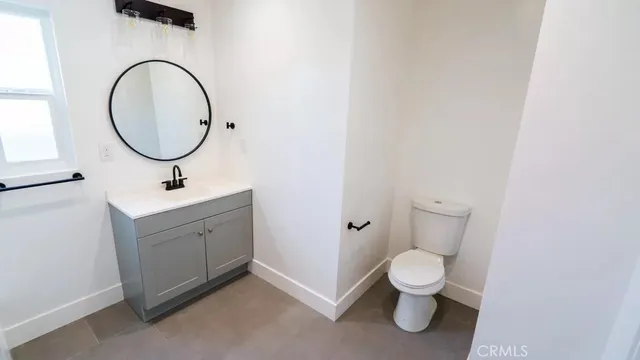 a kitchen with stainless steel appliances granite countertop a sink and a stove top oven with wooden floor