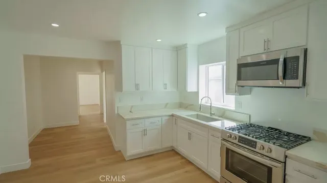 an empty room with a ceiling fan and carpet