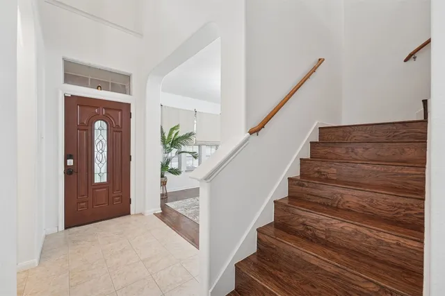 a view of entryway and hall with wooden floor